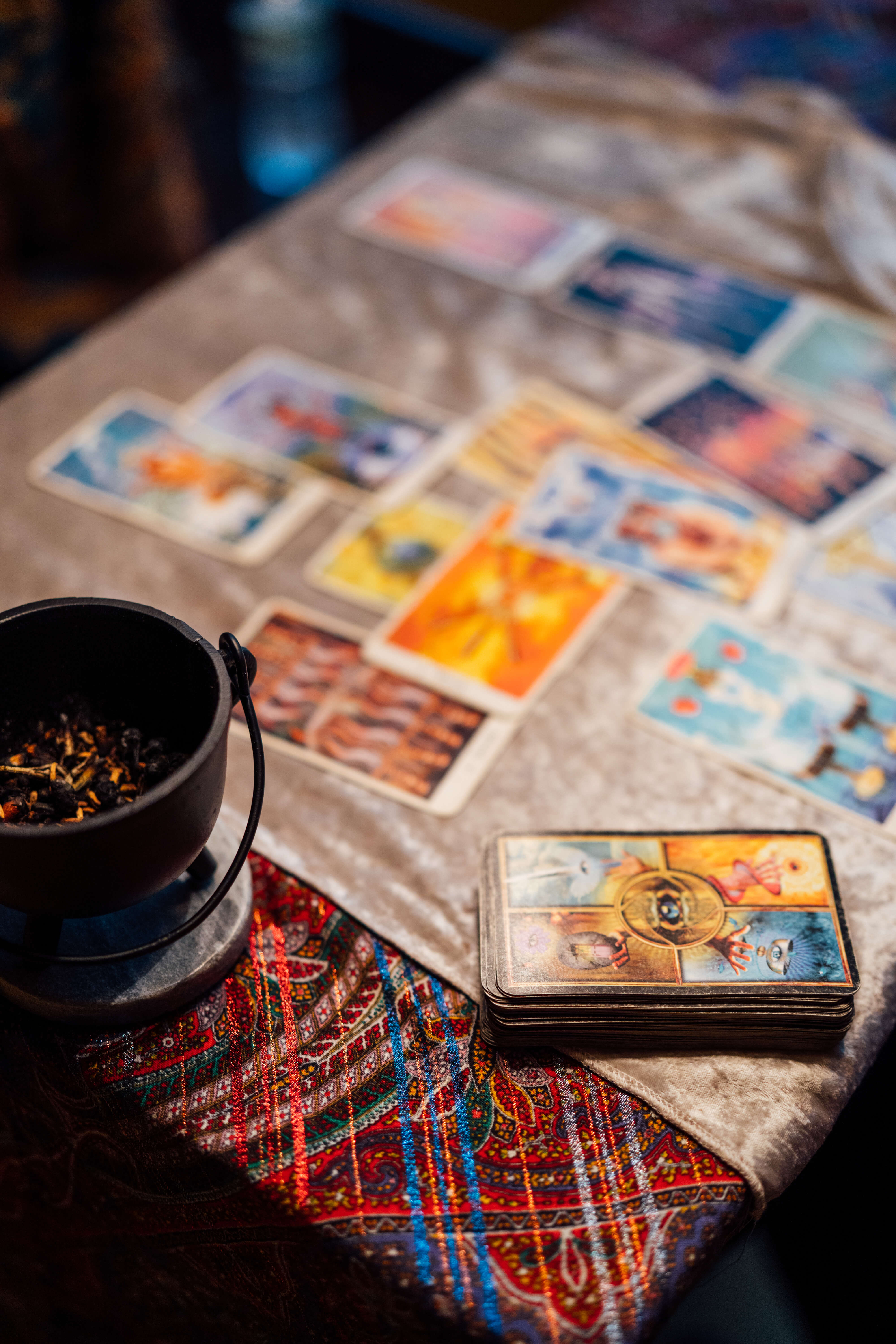 Tarot spread with cauldron and patterned cloth